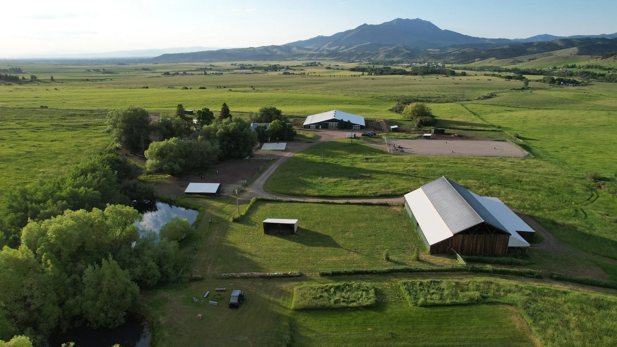Aerial of the barn, arena, and outbuildings below Mount Ellis